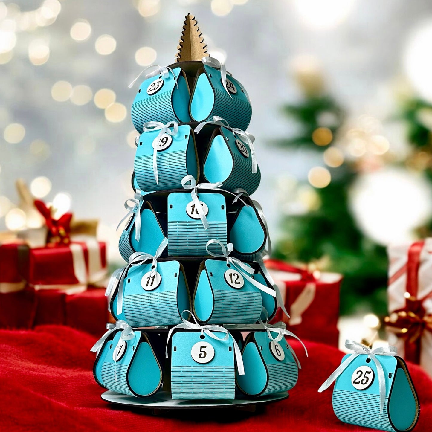 Blue advent calendar stacked in a tower with Christmas decorations in the background