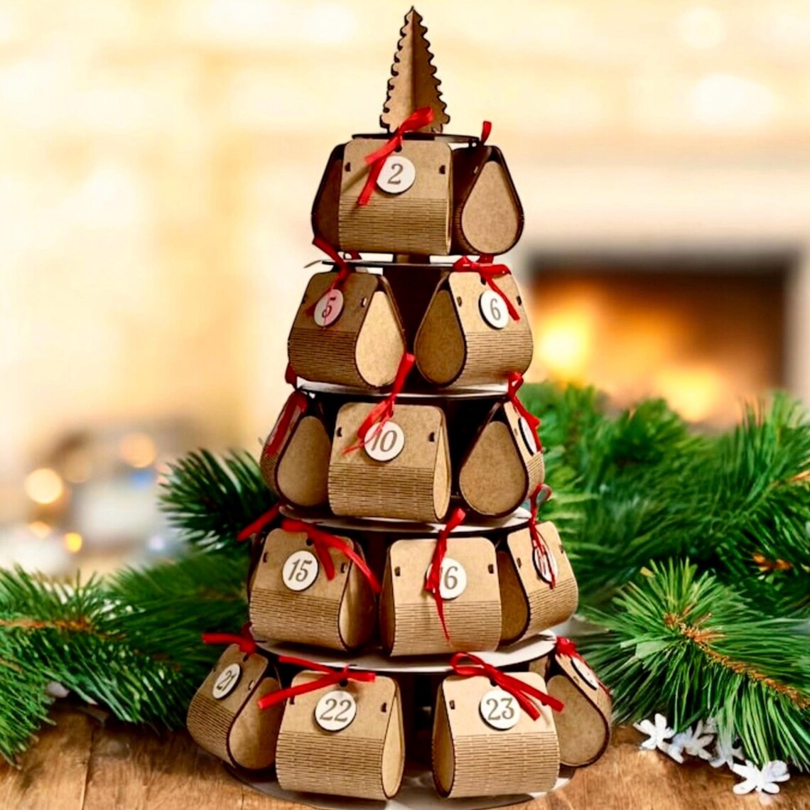 Wooden advent calendar stacked in a pyramid shape with Christmas decorations around.