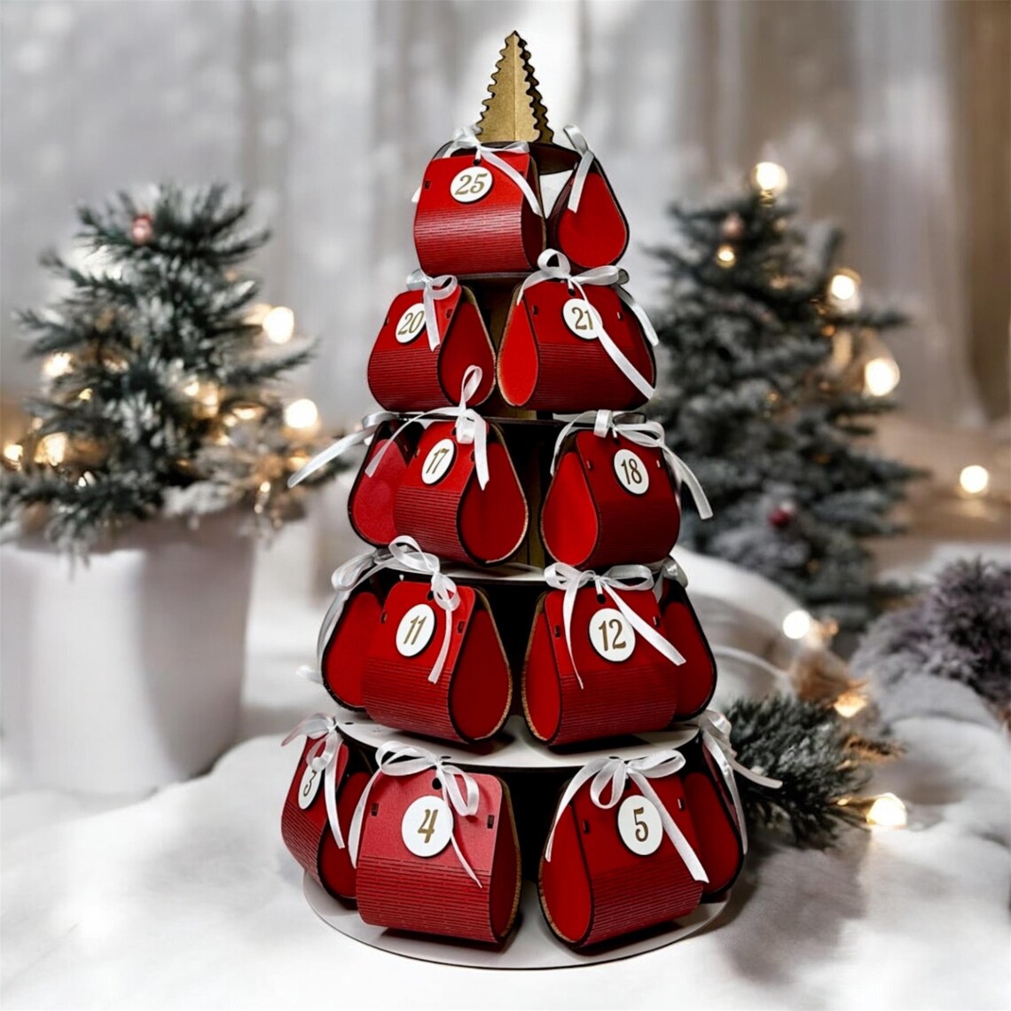 Red advent calendar with numbered boxes on a white surface with Christmas trees in the background