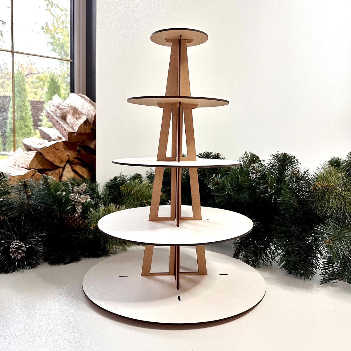 Wooden tiered display stand with white circular platforms 