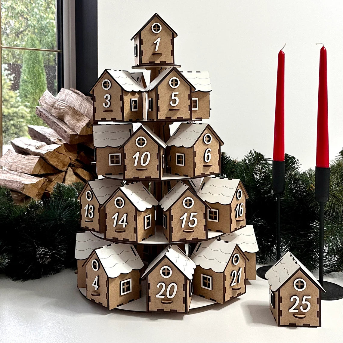 Wooden advent calendar with houses and red candles on a festive background