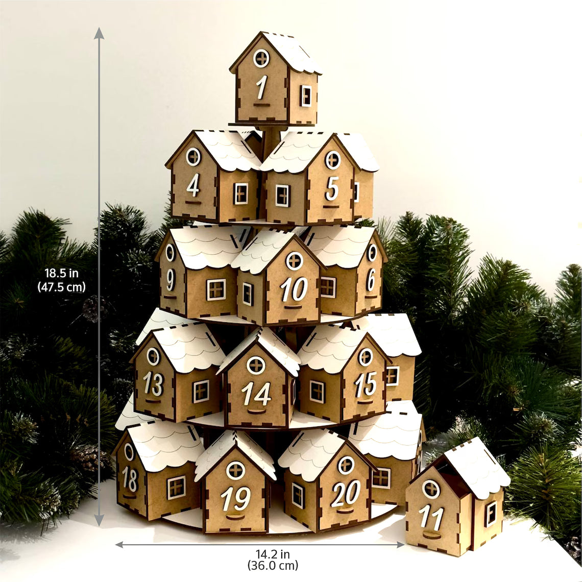 Stack of wooden houses with numbers, resembling an advent calendar, against a snowy background.