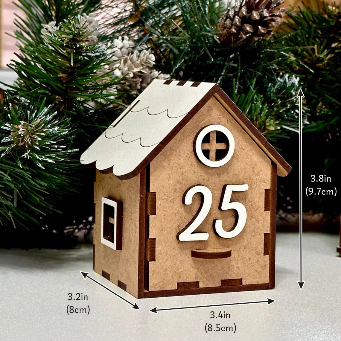 Wooden house-shaped ornament with number 25, Christmas tree in the background