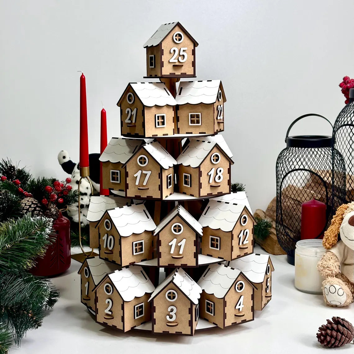 Wooden advent calendar with snow-covered houses on a white background