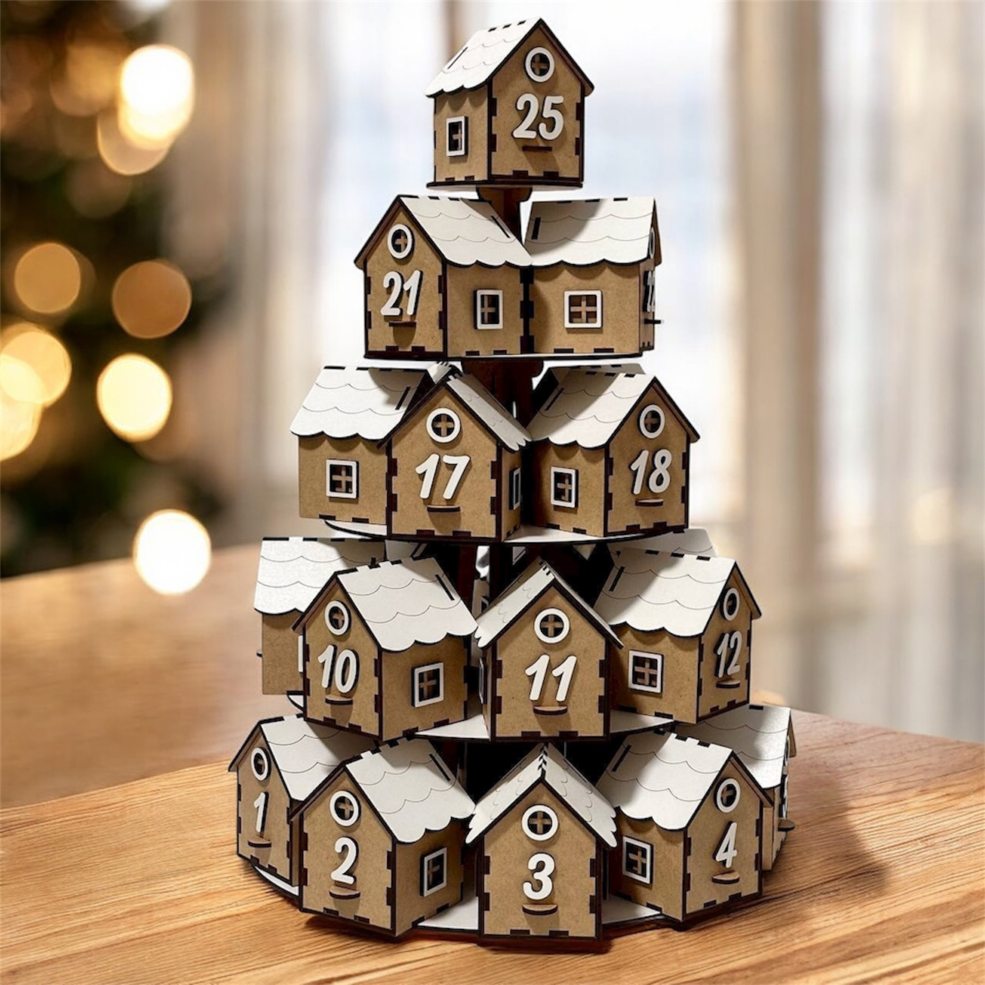Advent calendar with wooden houses stacked in a pyramid shape on a wooden surface.