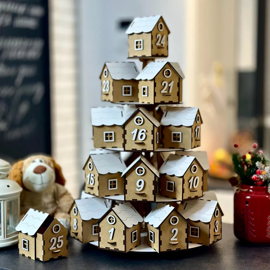 Wooden advent calendar shaped like a village with houses stacked on top of each other.