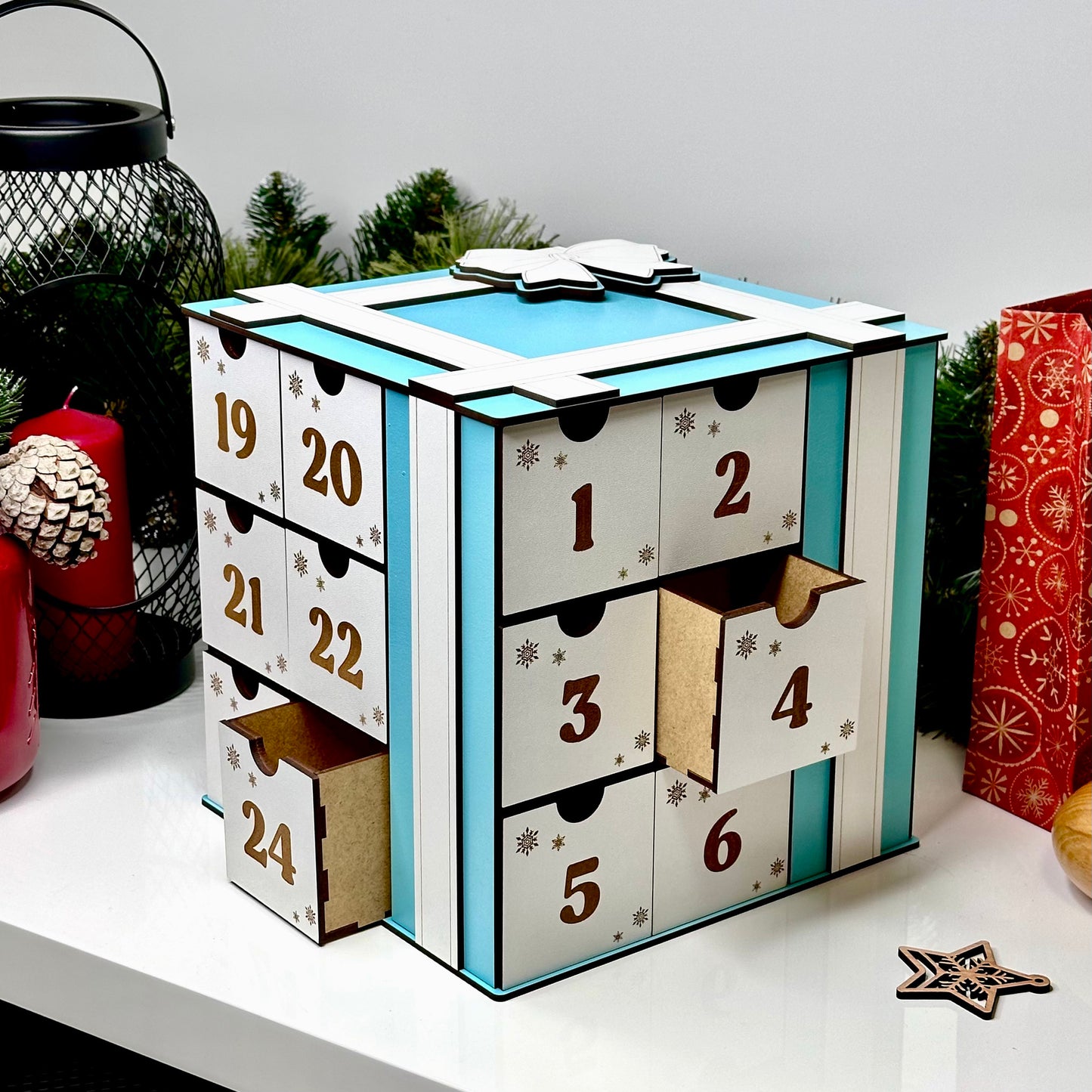 Advent calendar with numbered drawers on a white surface with decorative items.