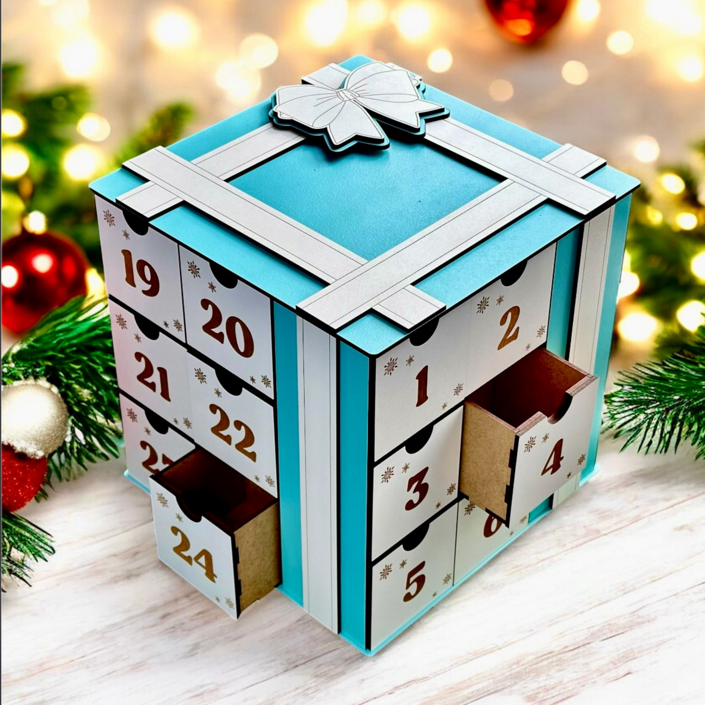 Advent calendar with blue lid and numbered drawers on a festive background