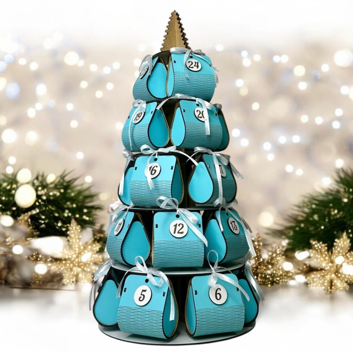 Teal advent calendar shaped like a Christmas tree with lights and decorations in the background