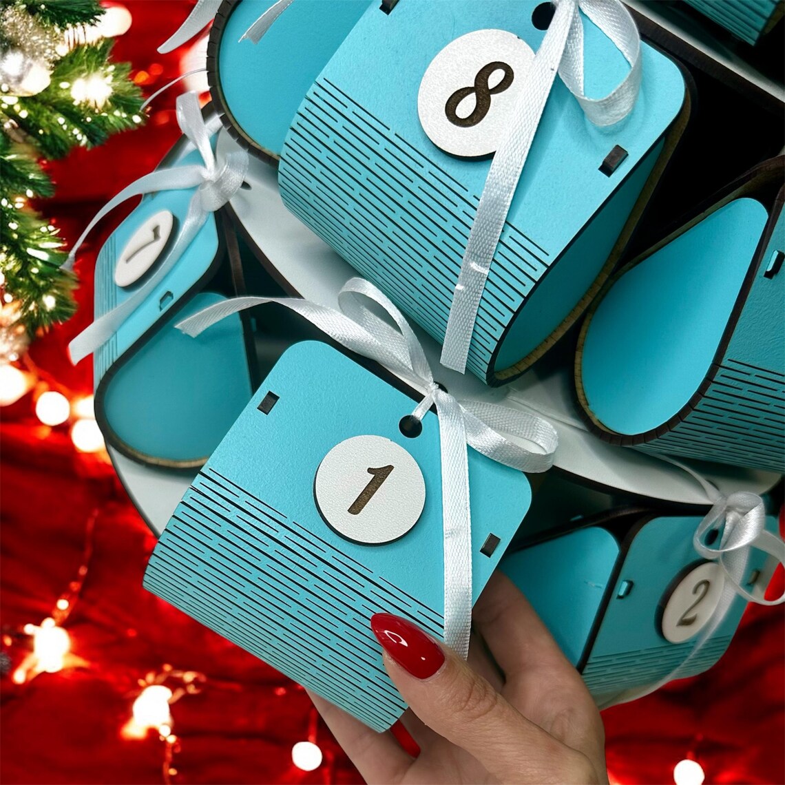 Blue advent calendar with white ribbon against a festive background