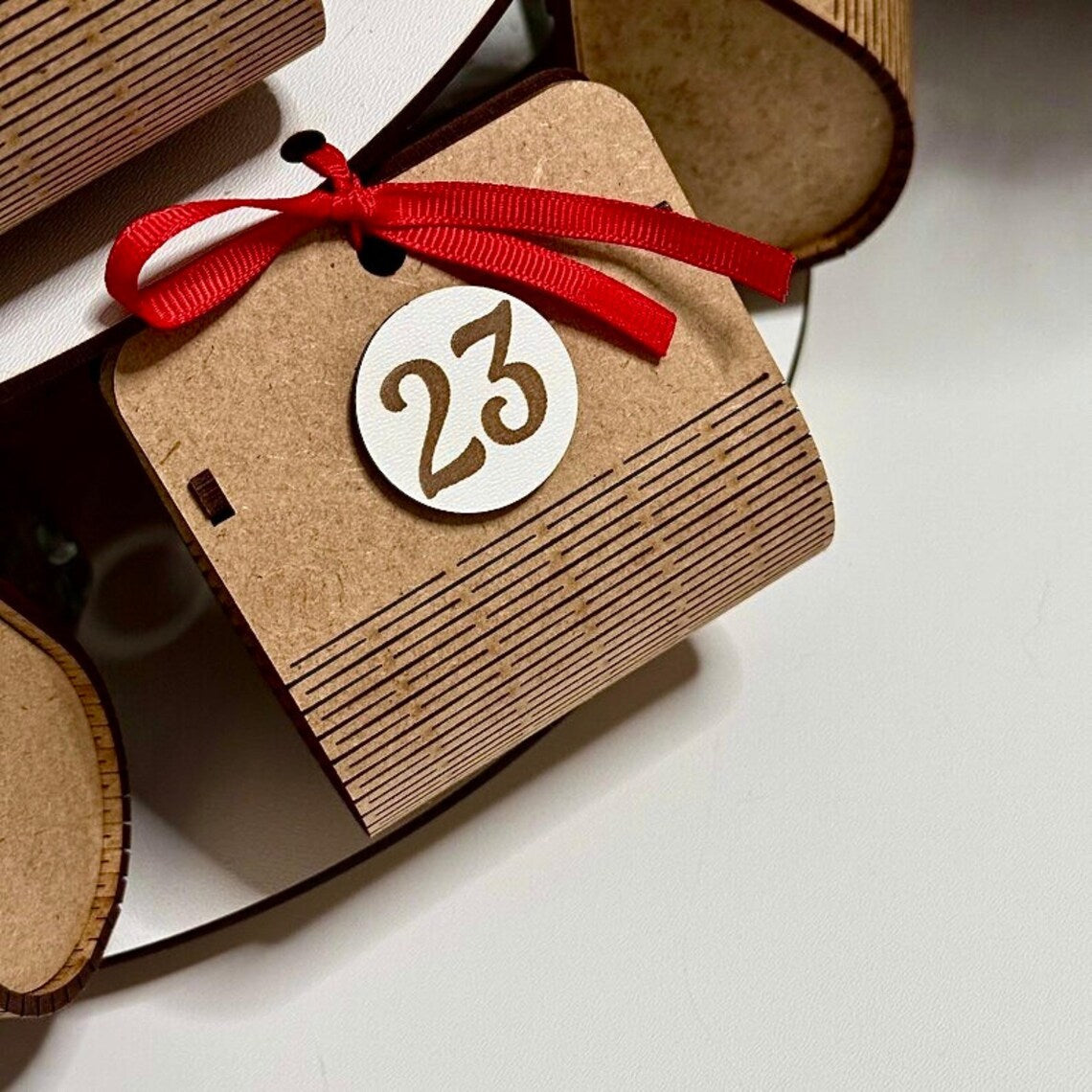 Advent calendar for Christmas holidays in the shape of a Christmas tree, made of wood