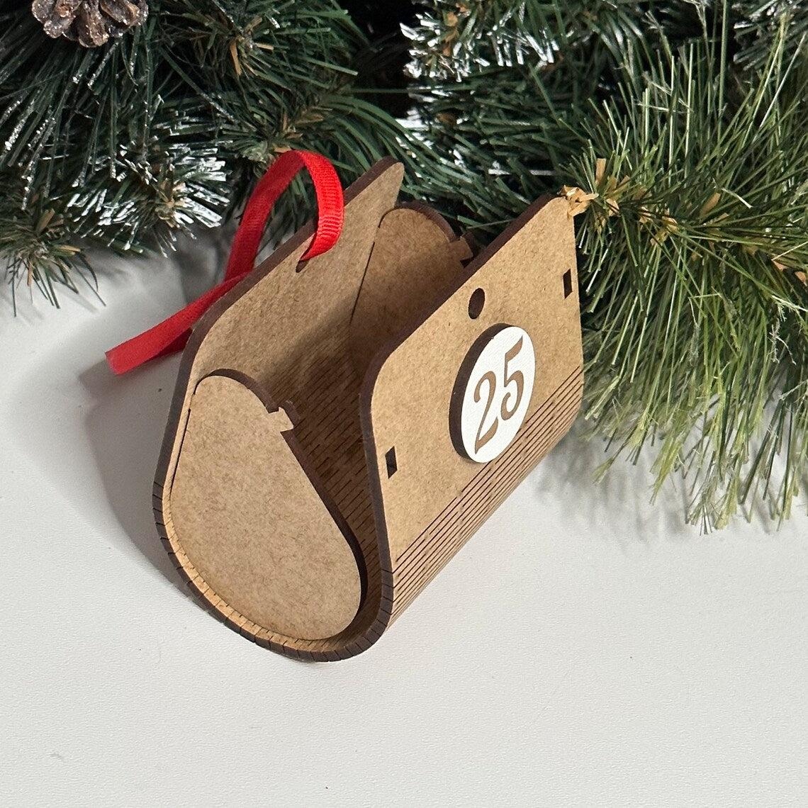 Advent calendar for Christmas holidays in the shape of a Christmas tree, made of wood