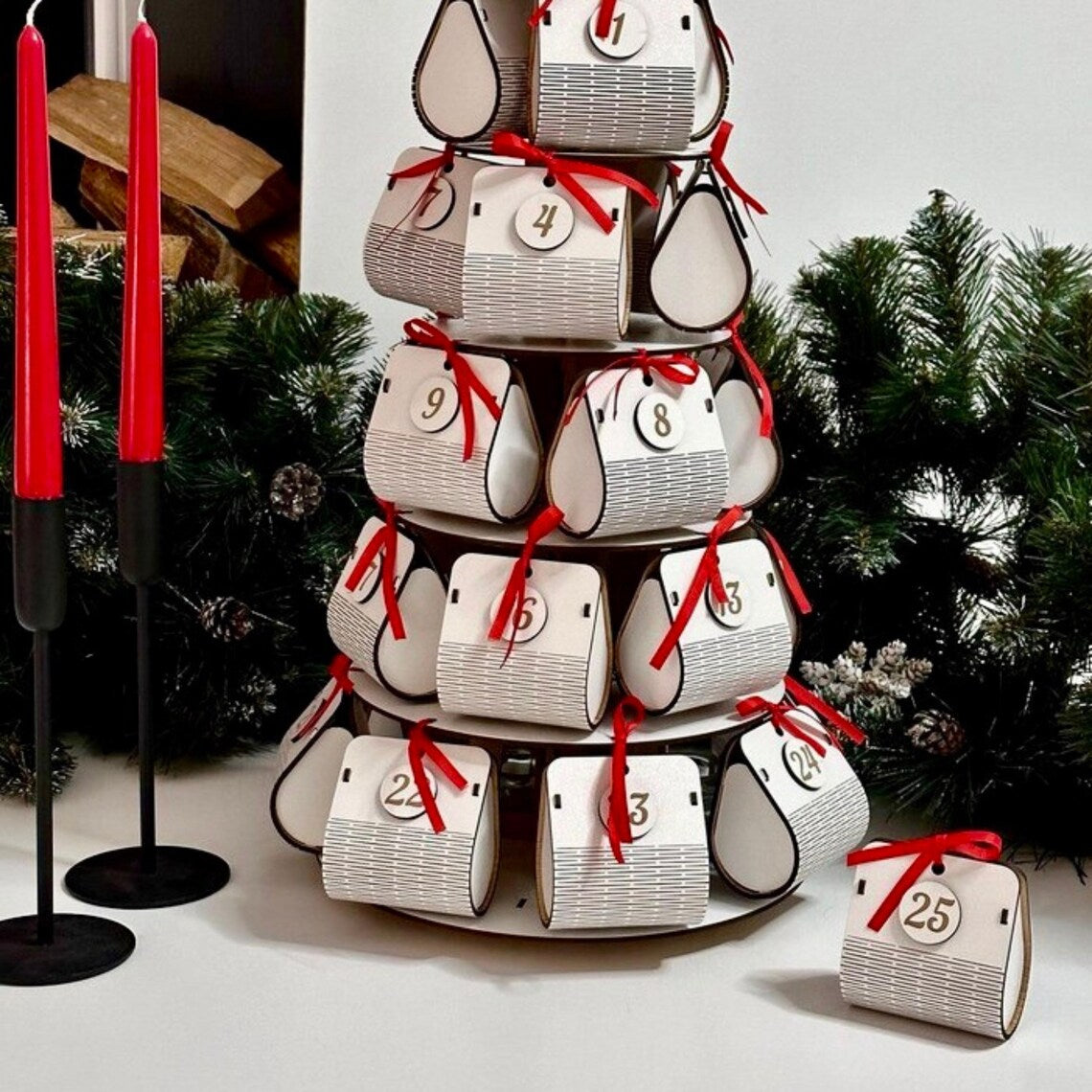 Advent calendar with numbered doors on a stand against a Christmas tree background