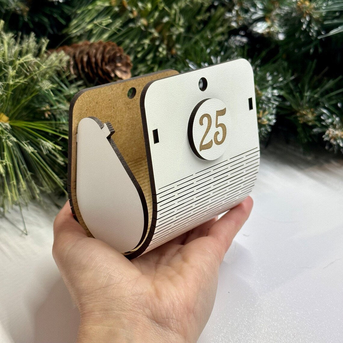 white wooden Advent calendar in the shape of a Christmas tree with spacious boxes