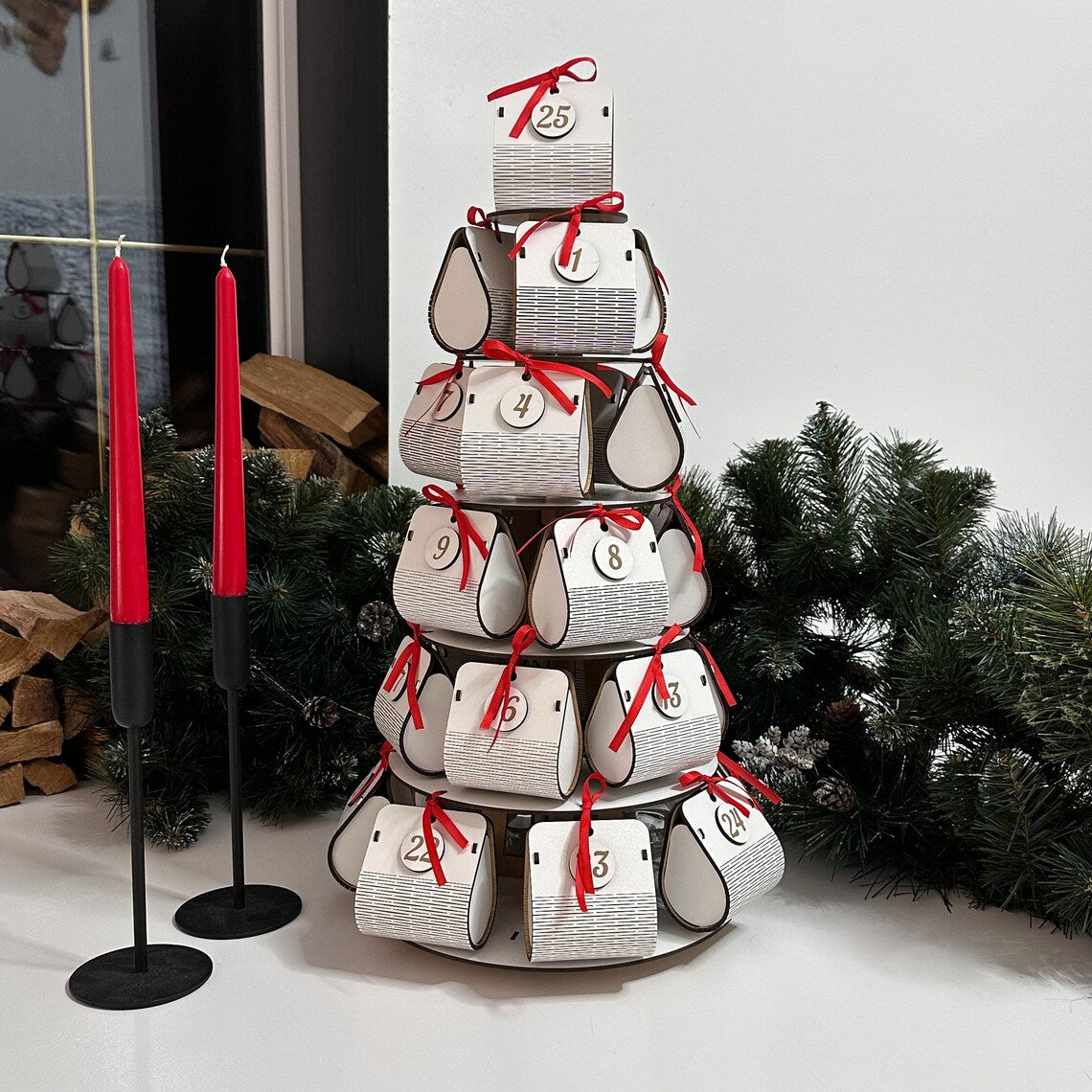 Decorative advent calendar with red ribbons and candles in a festive setting.