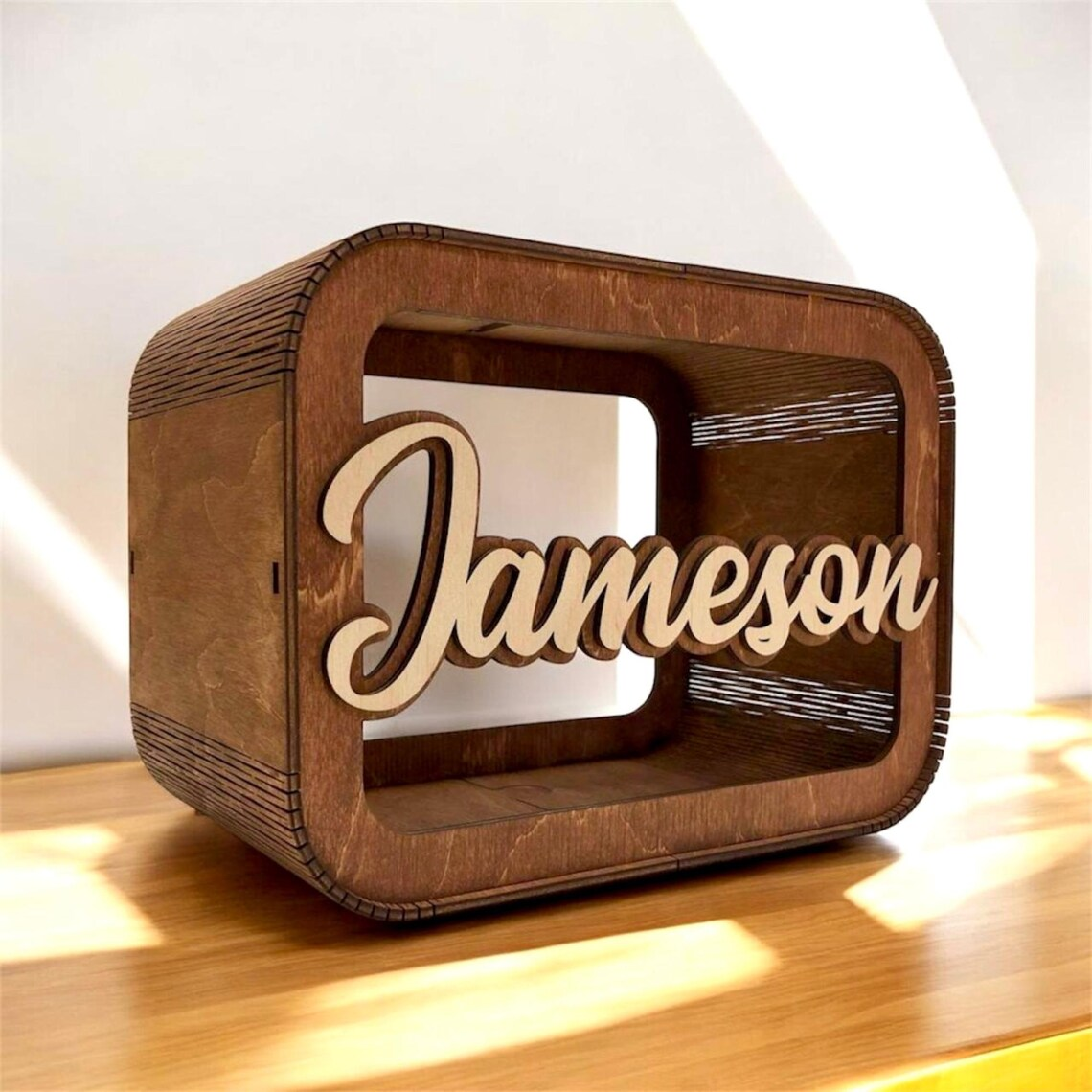 Wooden box with 'Jameson' engraved on a wooden surface