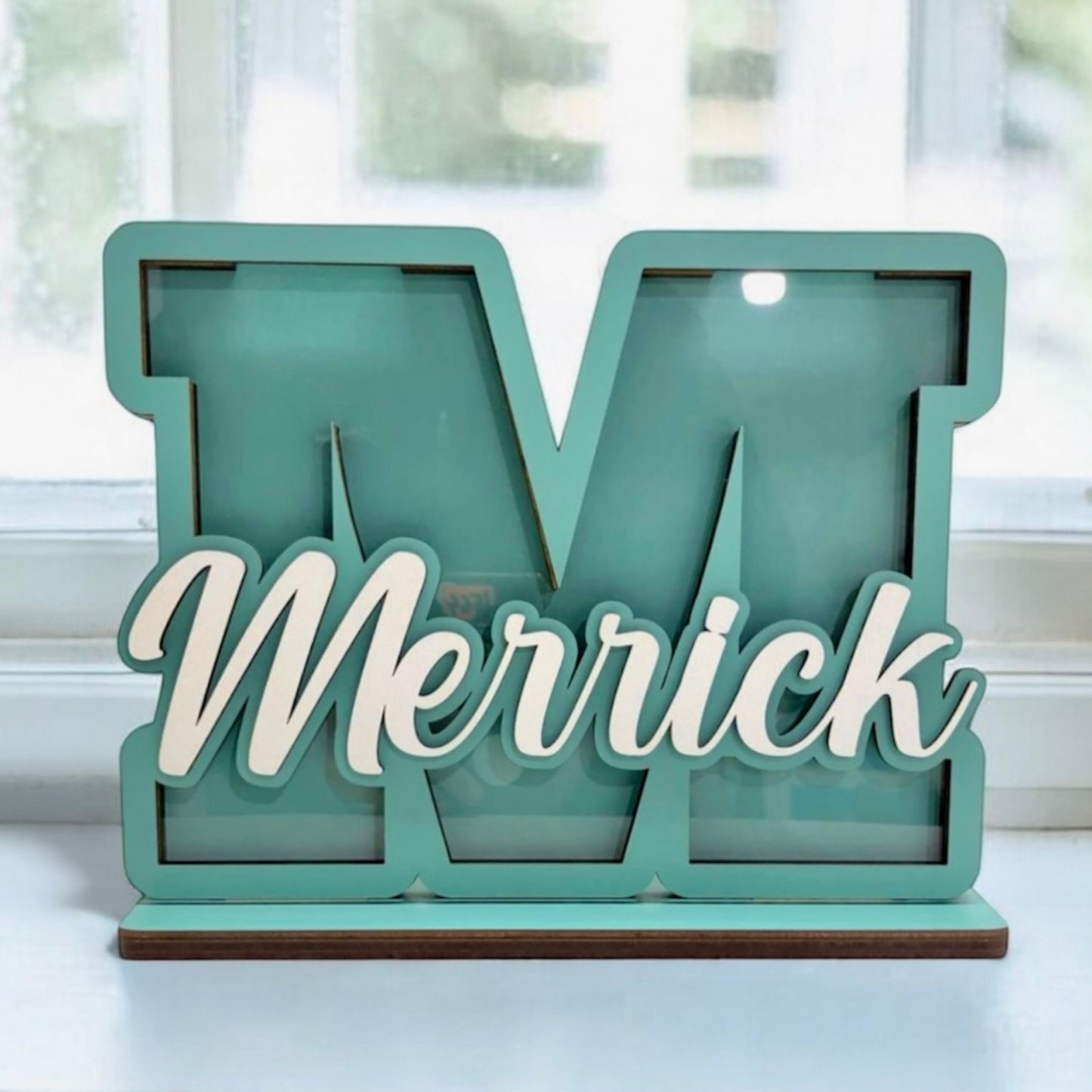 Teal letter 'M' with 'Merrick' in white on a light background