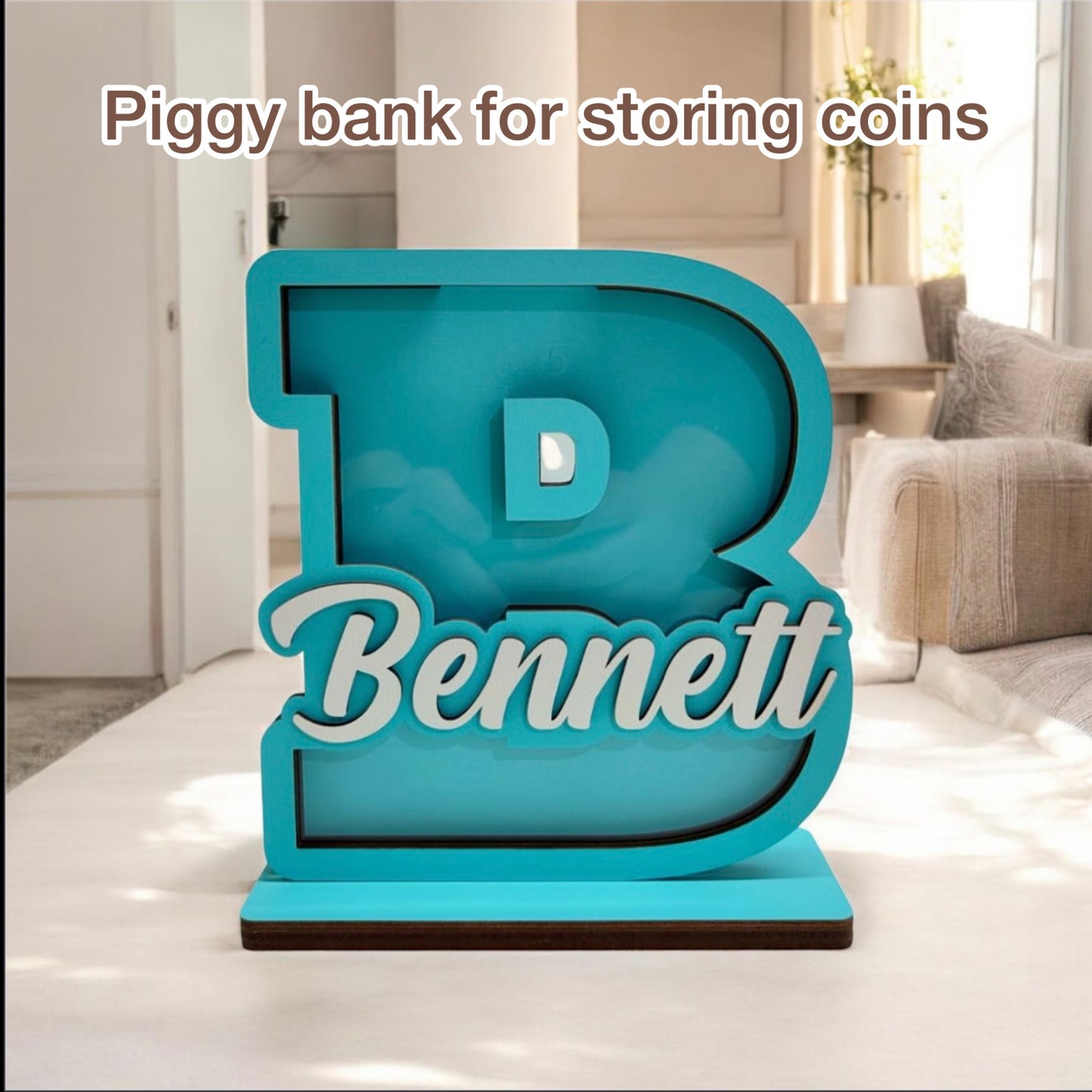 Turquoise piggy bank shaped like the letter 'B' with 'Bennett' on a white surface.