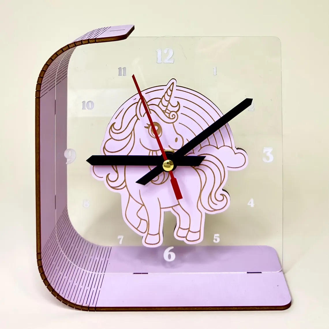 Unicorn-themed clock with a transparent design on a beige background