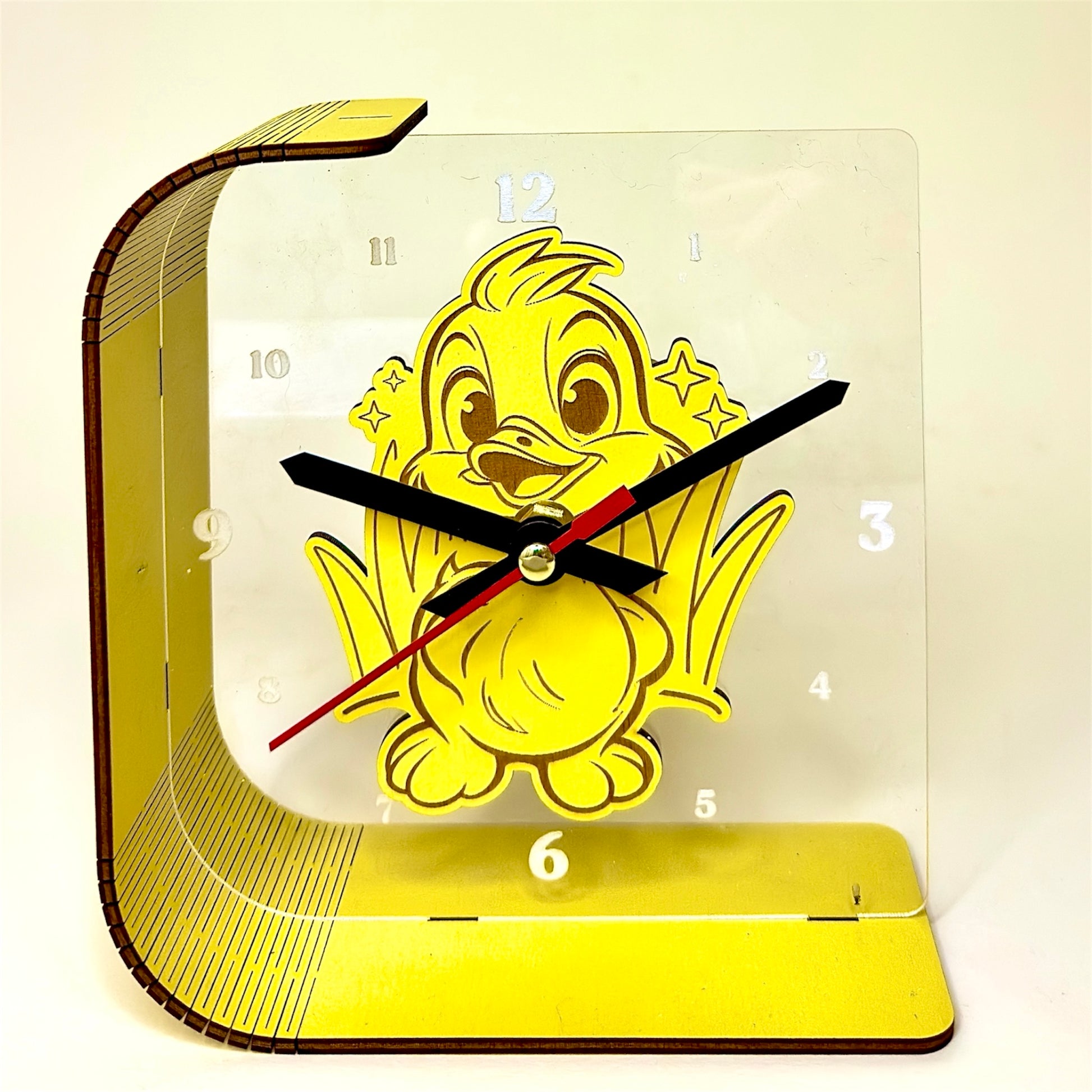 Yellow duckling clock with a transparent face on a white background