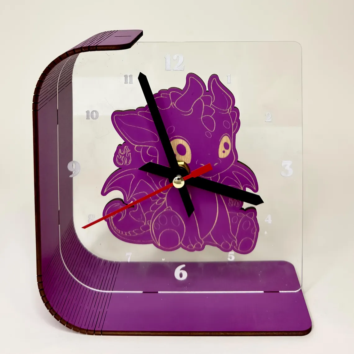 Purple clock with a cartoon character design on a beige background