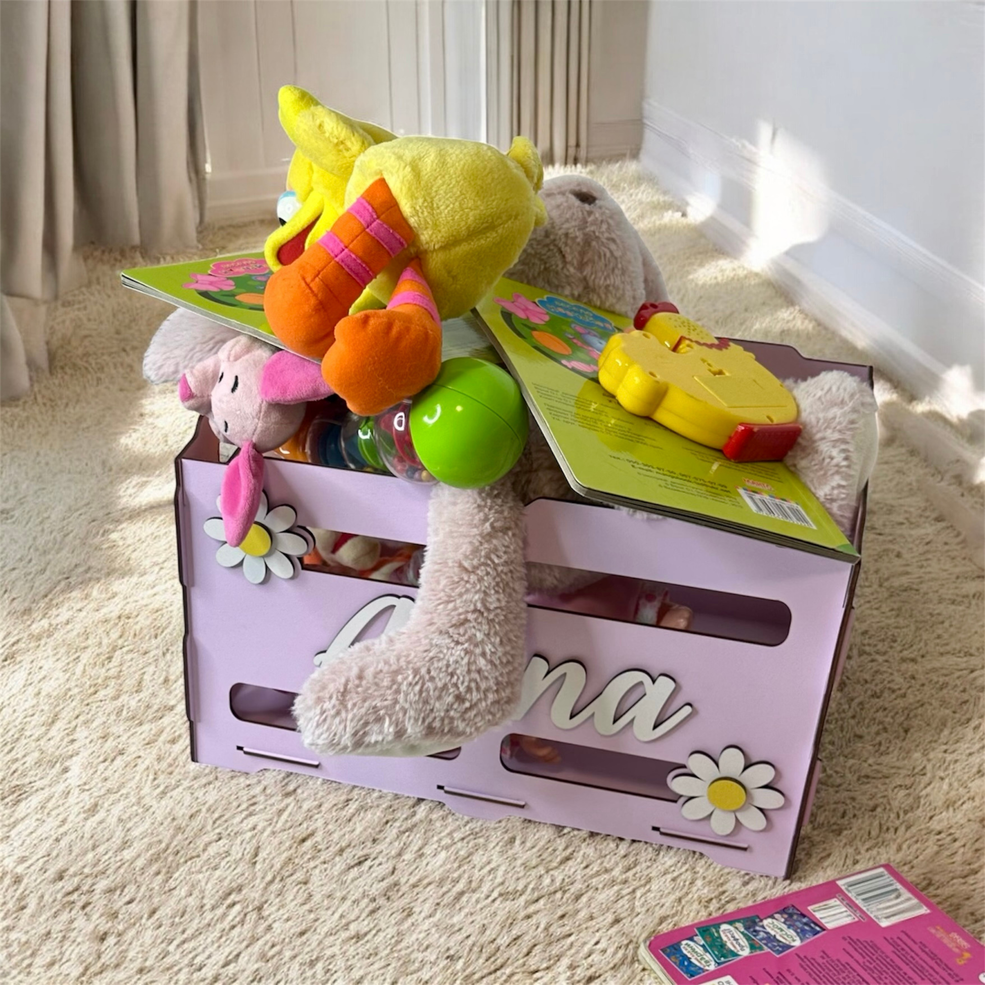 Toy box with toys on a carpeted floor
