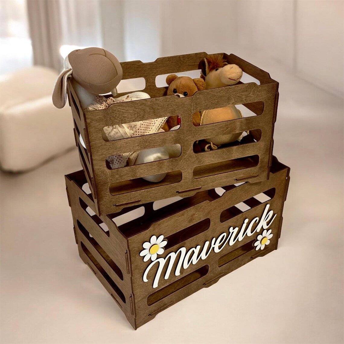 Stack of wooden crates with stuffed toys on a light background