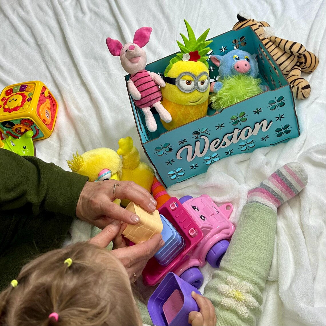 personalized wooden toy box for children, beautifully carved, with toys inside