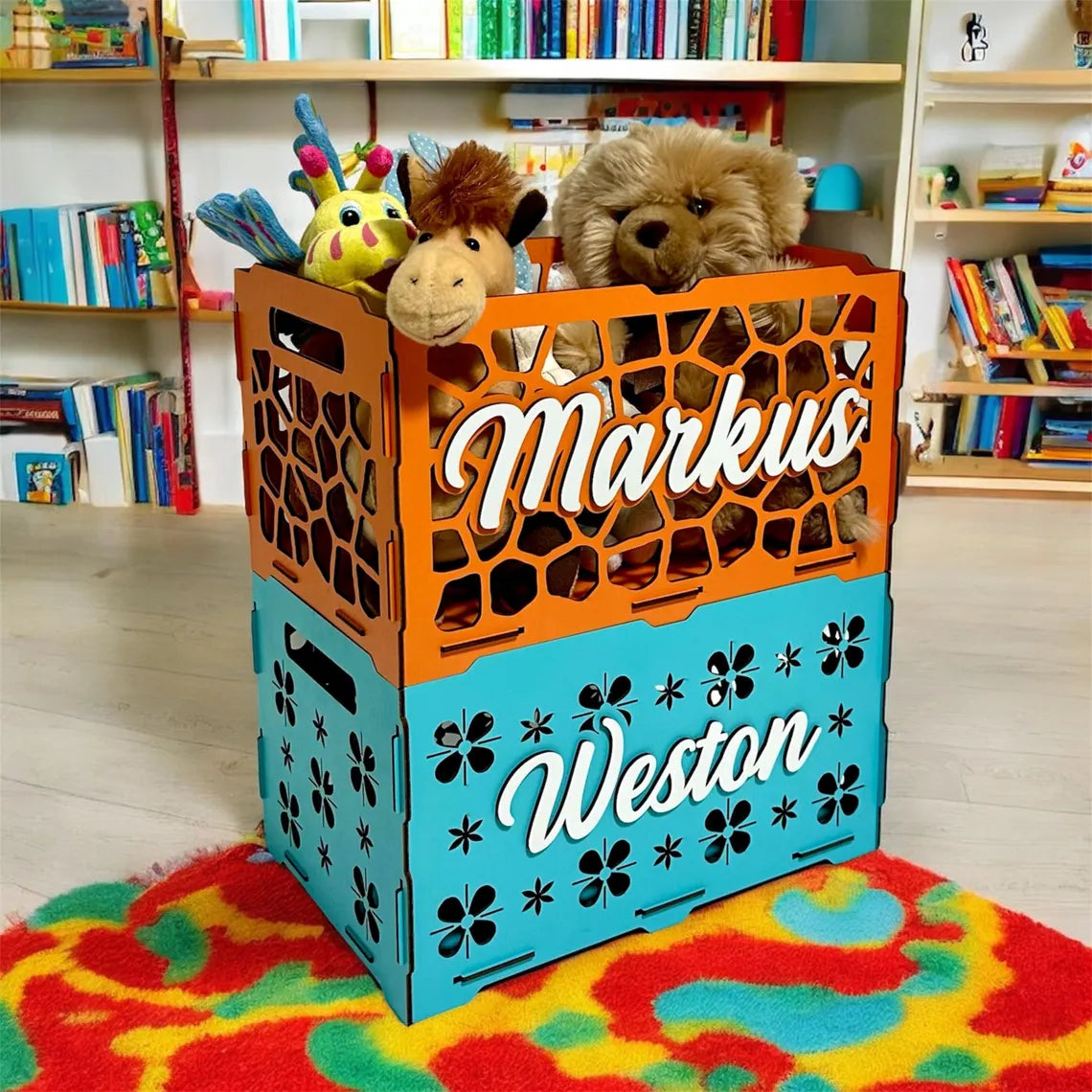 Orange and blue crate with stuffed animals inside, placed on a colorful rug in a room with bookshelves.