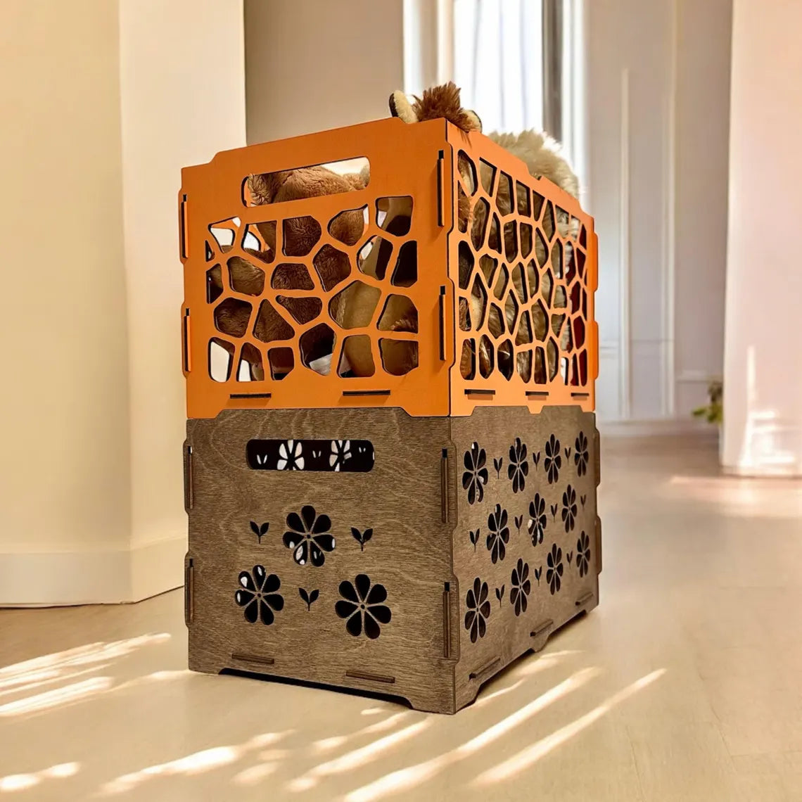 Decorative wooden crate with laser cut designs on a light floor.